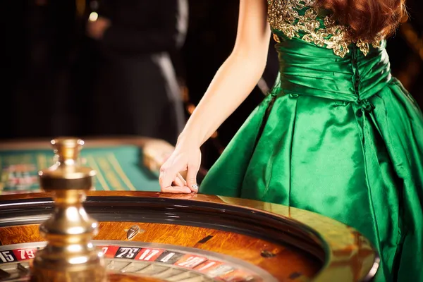 A young woman relaxing with her phone while dynamic casino elements float around her, illustrating the smooth mobile experience offered by the KM787 app.
