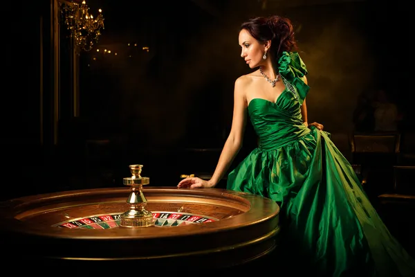 KM787 Slots — Thousands of exciting themes and jackpots A stylish woman beside vibrant slot machines displaying glowing sevens, showcasing the variety of top slots at KM787.