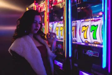A player using their smartphone during a festive local event, representing KM787’s fully mobile-friendly casino.